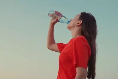 woman drinking water bottle